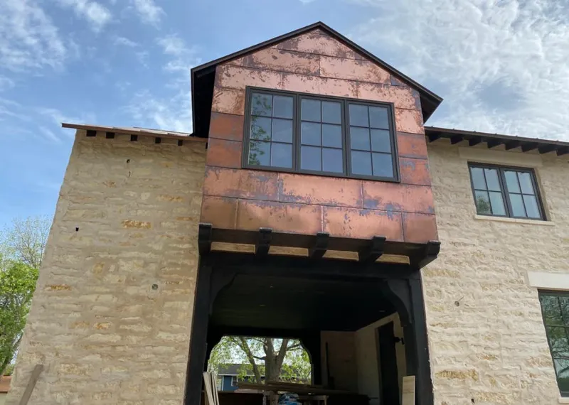 Copper metal panel facade on a stone building for Metal Roof Coating in Sheboygan