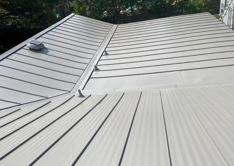 Solar attic fan installed on a metal roof for Roof Ventilation in Sheboygan